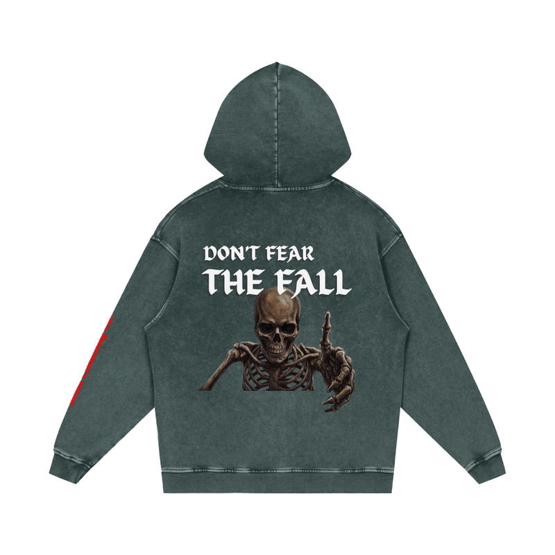 A dark gray-green hooded sweatshirt shown from the back, featuring a large graphic print of a skeleton with one hand raised and the text 'DON'T FEAR THE FALL' in white. A small red stripe is visible on the left sleeve.