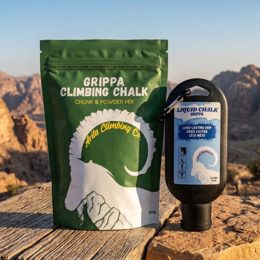 Grippa climbing chalk package and liquid chalk bottle on a rock with mountain background
