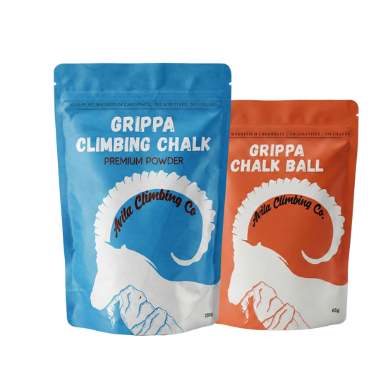 Two packages of Grippa Climbing Chalk, one blue and one orange, on a white background.