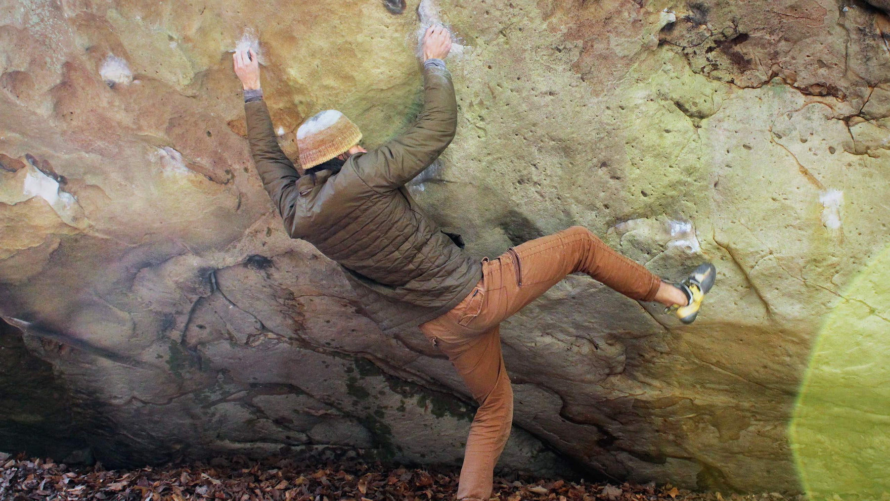 A climber using Avila CLimbing Co, Grippa chalk to climb a boulder